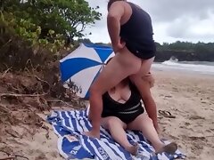 Blowjob on the beach with a very fat nudist,